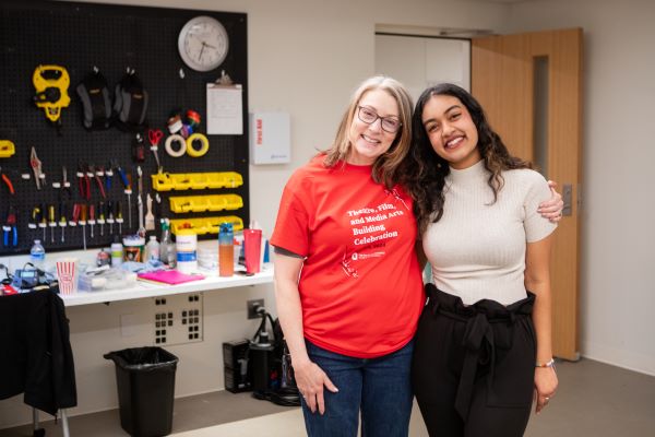 two women pose for the camera