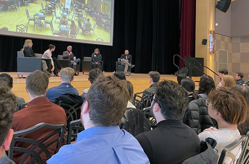 Panelists on a stage discuss their careers in sports