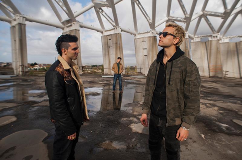 Three men standing in street. Suburra still.