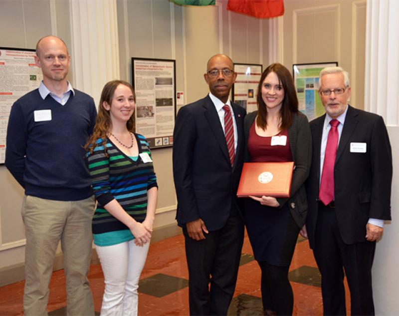 Beacom (left) and fellow astronomy professor Laura Lopez support former postdoc Katie Auchettl