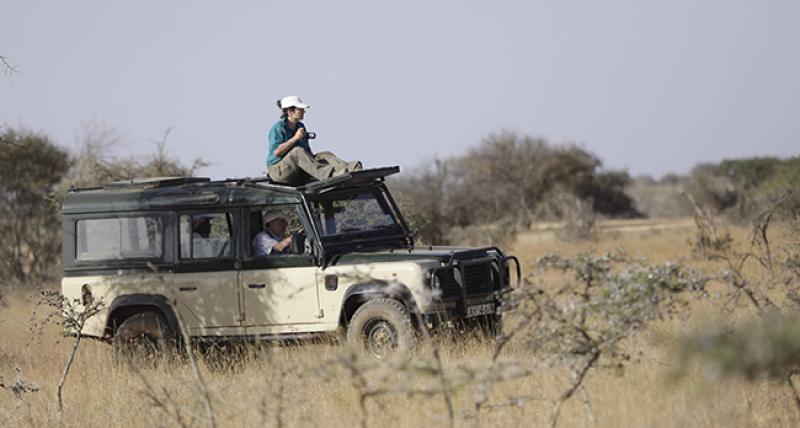 Tanya Berger-Wolf on top a vehicle with a camera