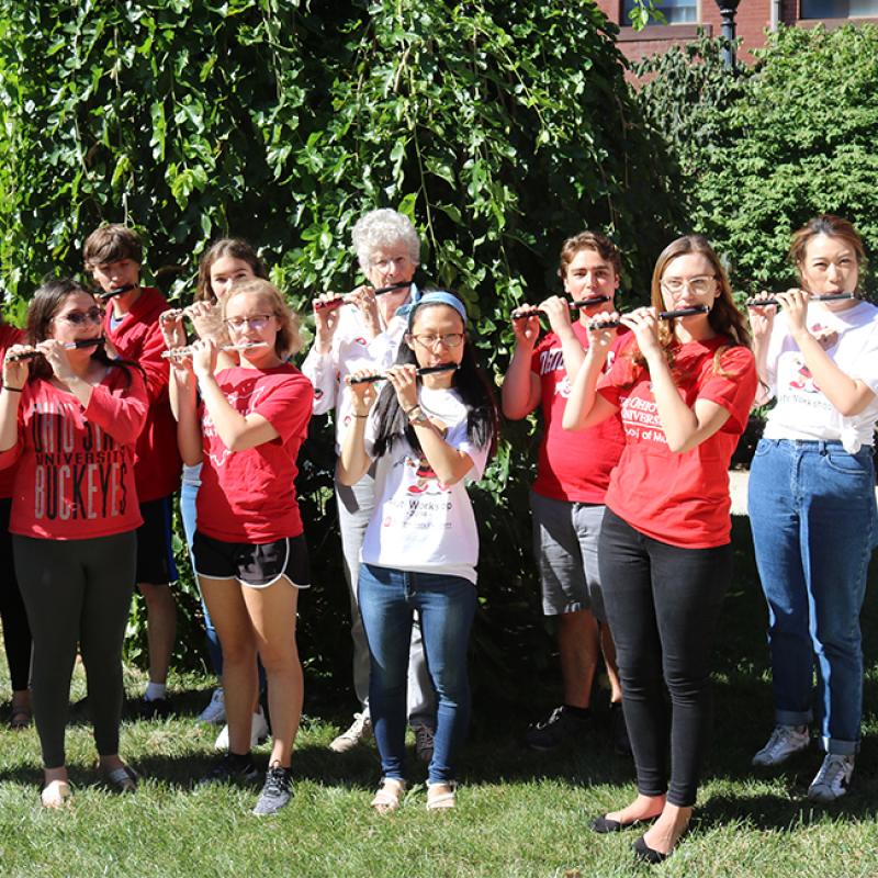 Jones and current School of Music students practice their piccolo performance in advance of marching with The Ohio State University Marching Band on Oct. 5