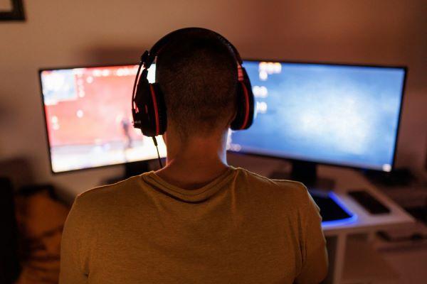 a person in headphones playing a PC game