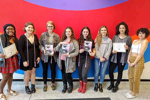 Students holding Triota journal