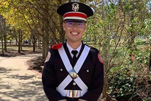 Christopher Lewis in marching band uniform